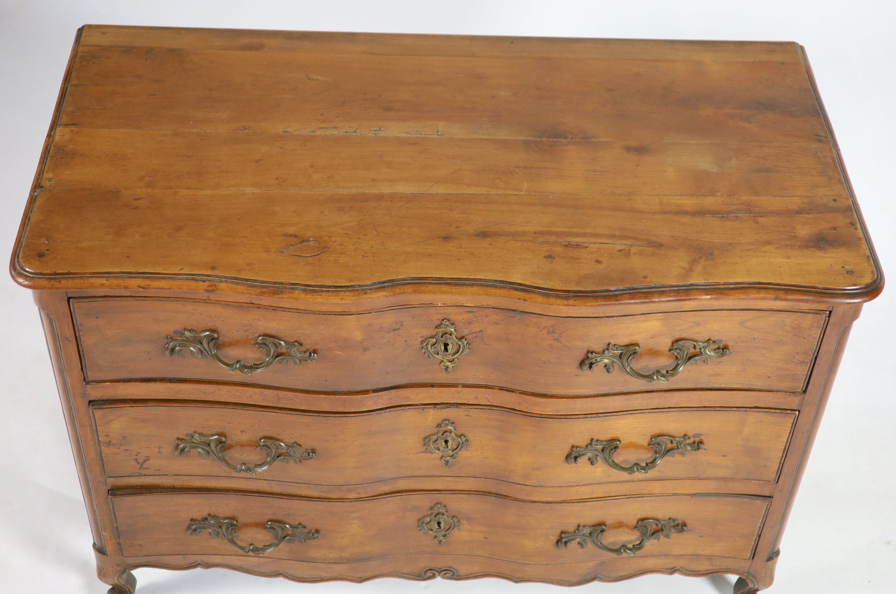 A Louis XV chestnut serpentine chest of three drawers, dated 1776, W.122cm D.63cm H.86cm